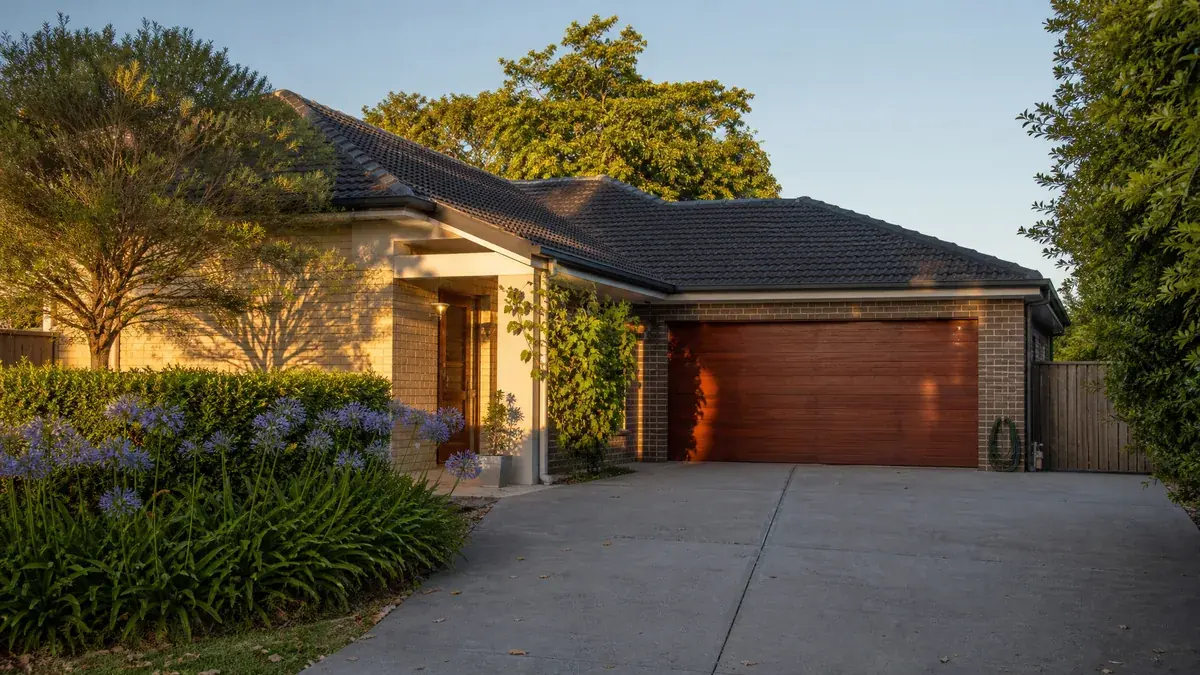 Well-kept Queensland family home at golden hour with a wide driveway